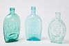 Three Embossed Glass Flasks