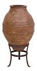 LARGE TERRACOTTA BANDED OLIVE JAR & IRON STAND
