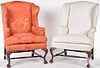 Two similar George III style carved wing chairs