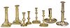 Eight brass candlesticks and tapersticks