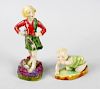 Two Royal Worcester figures modelled by F.G. Doughty. ‘Michael’, modelled as a crawling baby in gree