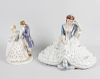 A group of porcelain figures, comprising a Royal Dux figurine modelled as a seated lady reading, wit