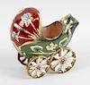 A majolica pram, decorated with stylised flowers upon a green and red glaze ground, raised upon four