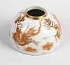 A Chinese porcelain brush pot or taibaizan. Of hemispherical form painted in burnt orange with drago