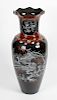 A floor-standing lacquered papier mache vase.Of ovoid form with wavy rim, the neck inlaid with panel
