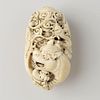 An unusual Japanese ivory netsuke. Of ovoid form, finely carved in deep relief with a dragon and a t