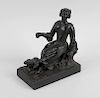 A bronze figure, circa 1800 modelled as a shepherdess seated on a tree stump beside a lamb, upon nat