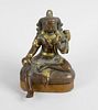 A South East Asian parcel gilt bronze figure, modelled as a deity holding a pearl and wearing elabor
