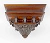 A large Victorian carved mahogany clock bracketThe moulded rectangular top over fielded panelled fri