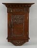 Arts & Crafts carved oak wall cupboard with floral decoration carved in relief, height 53cm, width 3