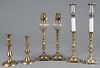 Pair of English brass candlesticks fitted with glass fonts, 15'' h., together with four other sticks.