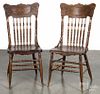 Pair of oak pressed back dining chairs, early 20th c.