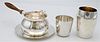 Tiffany and Asprey Four Piece Sterling Silver Lot, to include Aspray mug, Tiffany mug, and sauce dish with underplate, 24.6 t. oz.