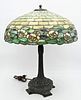 Attributed to Duffner and Kimberly Leaded Glass Table Lamp, having water lily band around bottom edge on bronze base, shade diameter 20 inches, height