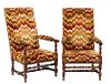 Pair of French Carved Oak Fauteuils a la Reine, 20th c. the high canted upholstered cushioned back flanked by upholstered arms over a like cushioned s