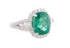 Lady's Platinum Dinner Ring, with an oval 4.31 ct. emerald, atop a border of small round diamonds, divided by two baguette diamond lugs, and a split s