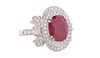 Lady's Platinum Dinner Ring, with an oval 3.37 ct. ruby atop a double graduated concentric ring of small round diamonds flanked by round and baguette 