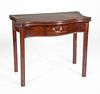 GEORGE III MAHOGANY SERPENTINE-FRONTED GAMES TABLE