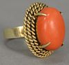 18K gold ring set with cabachon cut coral. 
ring size 6 1/2 in. 9.6 grams total weight