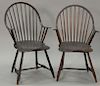 Pair of Continous Windsor armchairs with saddle seats in old brown paint. 
ht. 36 in.; seat ht. 17 in.