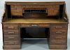 Derby oak S roll top desk with 28 drawers and pull out interior having high S roll and raised panels. 
ht. 51 in.; wd. 72 in.; dp. 3...