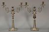 Pair of Continental silver candelabra, two lights each with fluted stems on square bases. 
ht. 16 in.; 49.9 t oz.