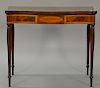 Sheraton mahogany game table having inlaid edges over burlwood oval center medallion panel, hinged top on reeded legs. 
ht. 29 in.; ...