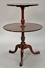 Margolis mahogany two tier table with dished top on turned shaft ending on tripod base. 
ht. 32 in.; top dia. 18 in.