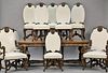 Eleven piece walnut dining room set with ten leather upholstered chairs, each with carved knight medallions, armchairs carved with f...
