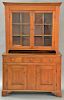 Chippendale stepback cupboard in two parts, upper portion having cornice molded top over two glazed doors on lower portion with thre...