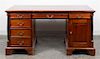 An Empire Style Mahogany Pedestal Desk Height 29 5/8 x width 60 x depth 29 3/8 inches.