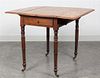 An American Mahogany Drop Leaf Table Height 28 1/2 x width 21 x depth 34 inches (closed).