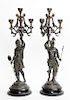 A Pair of Patinated Metal Figural Four-Light Candelabra Height 22 inches.
