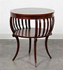 * A Regency Style Mahogany Drum Table Height 27 1/2 x diameter 23 3/4 inches.