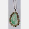 A Gold-Over Silver and Green Jade Pendant,