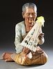 Burmese Carved Polychromed Figure of a Seated Older Woman, 20th/21st c., holding an umbrella, H.- 23 1/2 in., W.- 15 in., D.- 16 in.