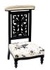 French Ebonized Beech Prie Dieu, c. 1880, the curved upholstered armrest over a pierced well carved leaf splat, to a trapezoidal bowed kneeler, on tur