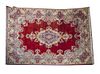 Persian kirman rug Mid 20th century Polychromed Persian Kirman rug, fringed ends, floral motifs throughout, center medallion and 2 guard boarders 
(A