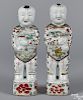 Pair of Chinese famille verte figures of Ho Ho boys, early 19th c., each holding a vase