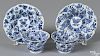 Pair of Chinese Kangxi blue and white porcelain cups and saucers with foliate decoration.