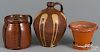 Three pieces of redware, 19th c., to include a jug with yellow slip decoration, 9 3/4'' h.
