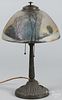 Patinated white metal table lamp, early 20th c., with a reverse painted shade, 19'' h., 12'' w.
