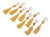 * A Set of Sixteen Amber Drapery Ornaments Length 12 1/4 inches.