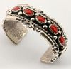 A HEAVY NAVAJO STERLING AND CORAL CUFF BRACELET