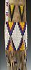 A 20TH C. PLAINS INDIAN BEADED AND FRINGED HIDE PIPE