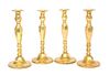 A Set of Four Brass Candlesticks