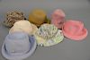 Seven Eric Javits squishee straw sun hats including pink, blue, natural, light pink, suede, and two others.