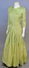 Christian Dior, Spring/Summer 1986, Evening dress of chartreuse silk. The skirt is gathered into the wrapped hip yoke; the bodice also has a wrapped e