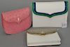 Three Lana of London handbags including pink ostrich skin bag (never used), a snake skin purse, and a white snake skin clutch purse.