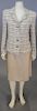 Chanel two piece beige suit including tweed jacket and A-frame skirt.